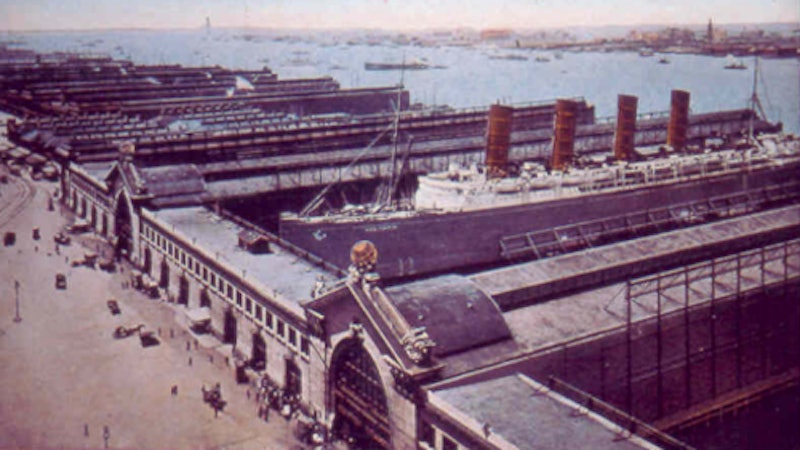 Post card shows the Cunard’s ill-fated Lusitania at Pier 54 of the Chelsea Piers, which were designed by Grand Central Station architects Warren and Wetmore.