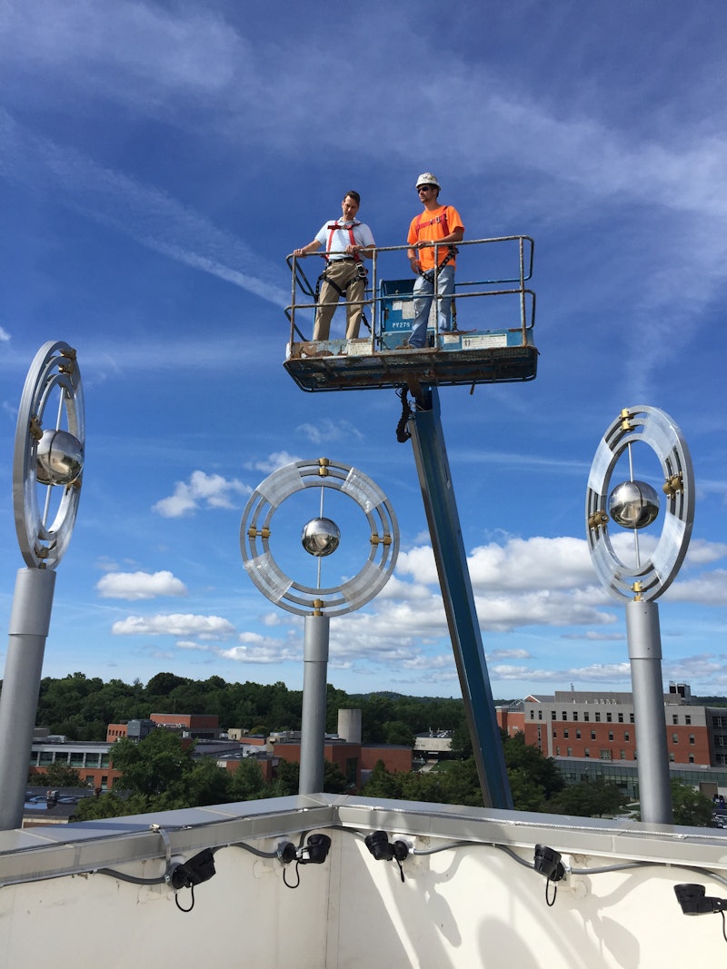 Reno Migani (left) during installation